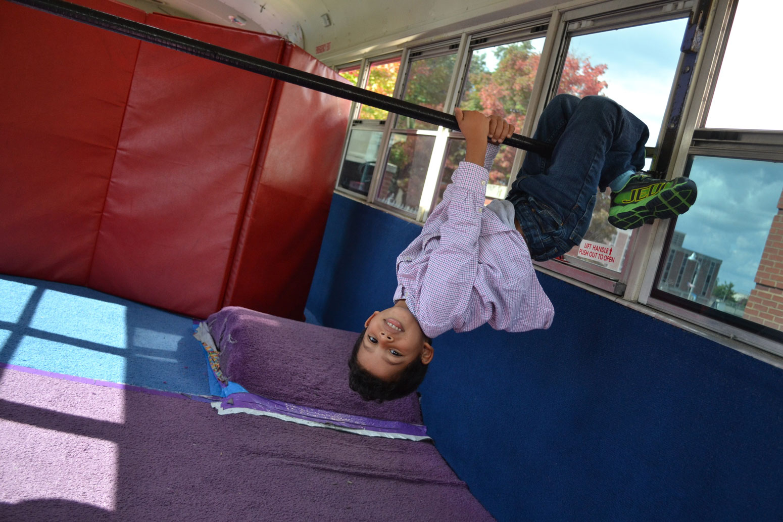 Boy Hanging From Bar